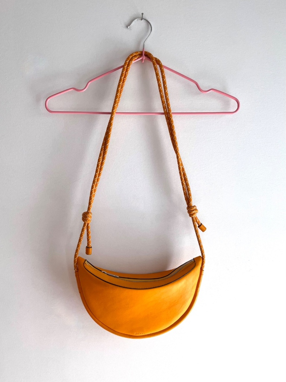Leather paracord strap crossbody sling bag in orange by Ecco